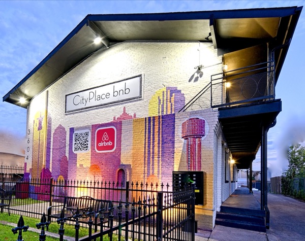 CityPlace bnb mural facade with steel exterior staircase at dusk