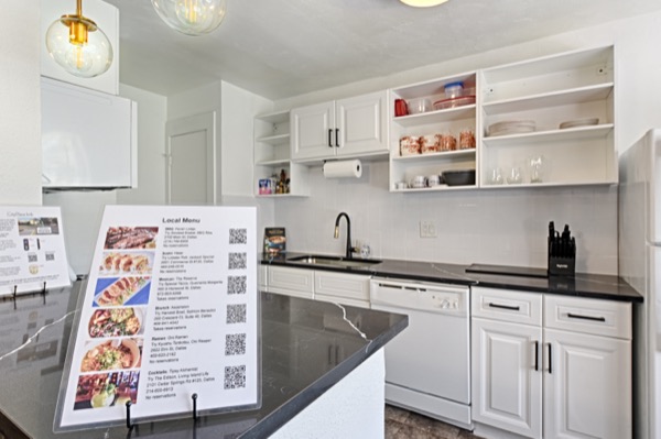 Kitchen island with black quartz counter and printed local guide