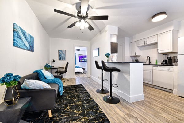 Suite 101 living area with breakfast bar and kitchen beyond