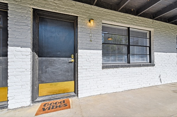 Suite entrance with smart lock and welcome mat